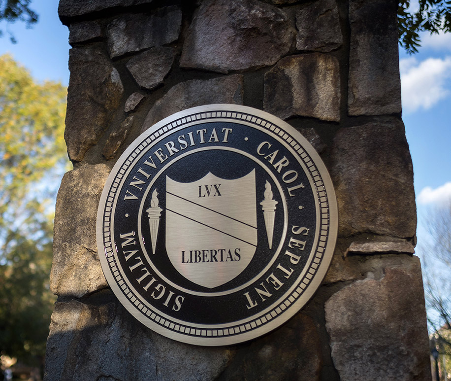The UNC-Chapel Hill seal on a stone wall.